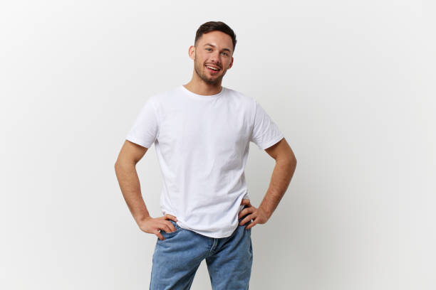istock Happy cheerful tanned handsome man in basic t-shirt smile at camera posing isolated on over white studio background. Copy space Banner Mockup. People emotions Lifestyle concept. Model snapshots 2148231409