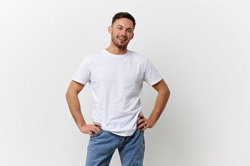 Happy cheerful tanned handsome man in basic t-shirt smile at camera posing isolated on over white studio background. Copy space Banner Mockup. People emotions Lifestyle concept. Model snapshots