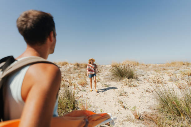 istock Loving couple exploring new sandy beach together 2148231454