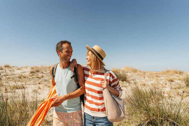 istock Loving couple exploring new sandy beach together 2148231487