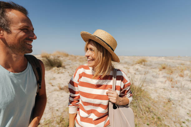 istock Loving couple exploring new sandy beach together 2148231488