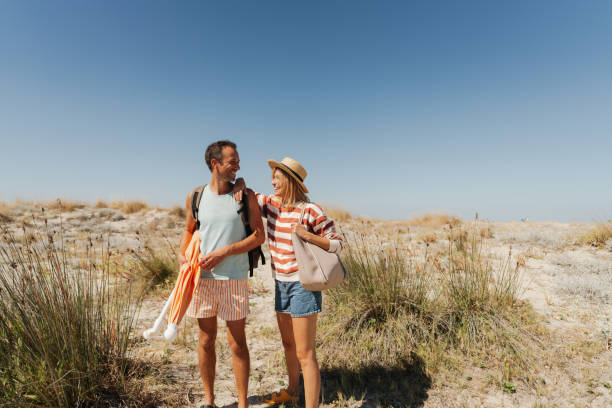 istock Loving couple exploring new sandy beach together 2148231505