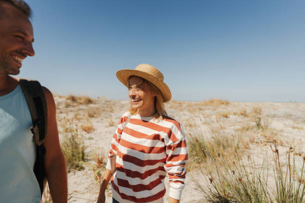 istock Loving couple exploring new sandy beach together 2148231506