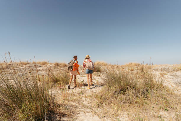 istock Loving couple exploring new sandy beach together 2148231519