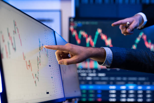 istock Stock traders pointing highest stock market on dynamic valued unit. Sellable. 2148231569