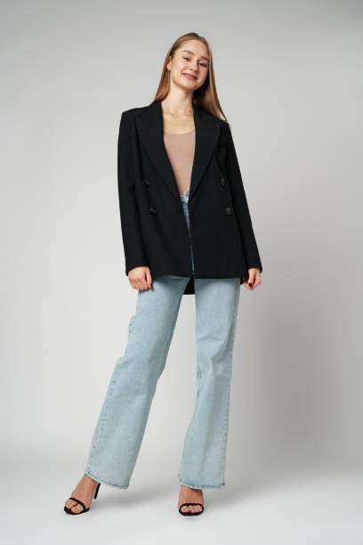 istock Young Woman Wearing Black Jacket and Jeans posing on gray background studio shot . 2148231777