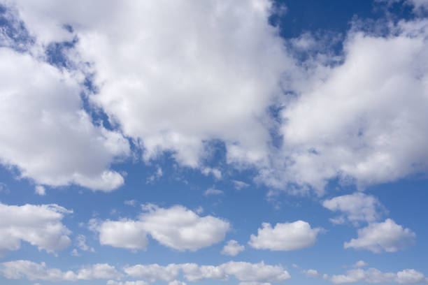 A stunning view of a bright blue sky adorned with fluffy white clouds, perfect for serene landscapes.