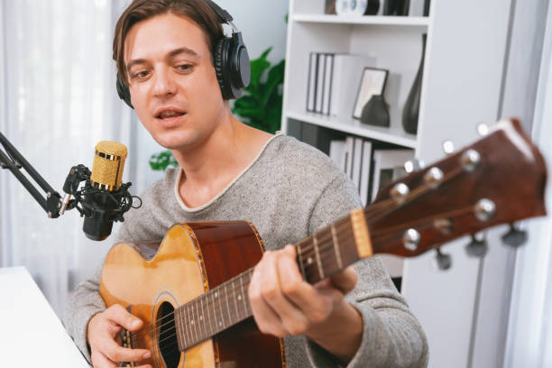 istock Singer with smile face on social media, playing guitar along singing. Pecuniary. 2148232766