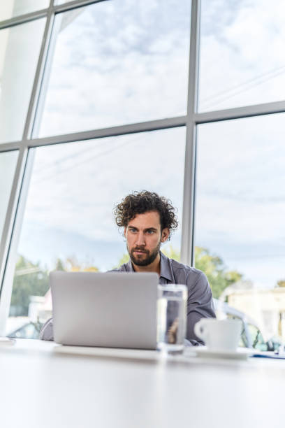 istock Young male entrepreneur working on laptop in the office. 2148232767