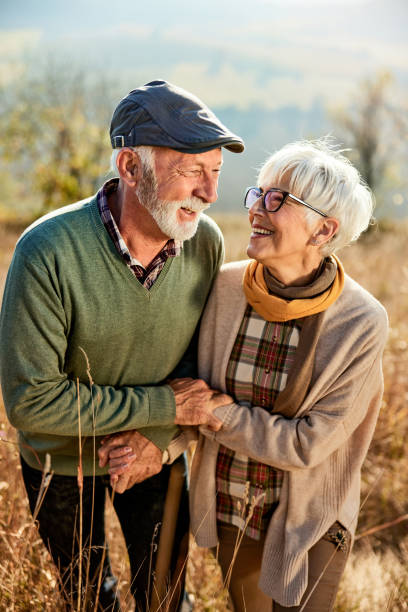 istock Happy senior couple taking an autumn walk in a meadow. 2148233277