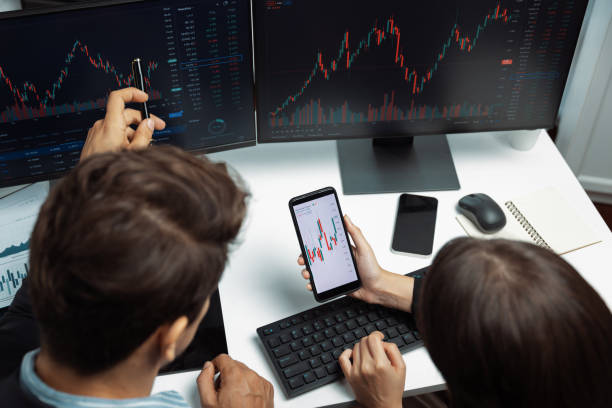 istock Top view focusing phone discussing stock market two business traders. Postulate. 2148233336