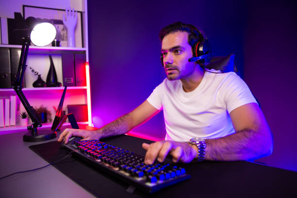 istock Serious face streamer concentrating gaming player trying to pass level. Surmise. 2148233780