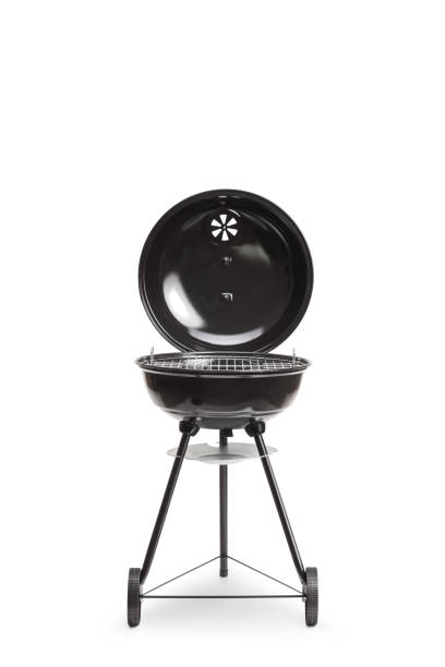 empty charcoal grill on green grass background in the garden