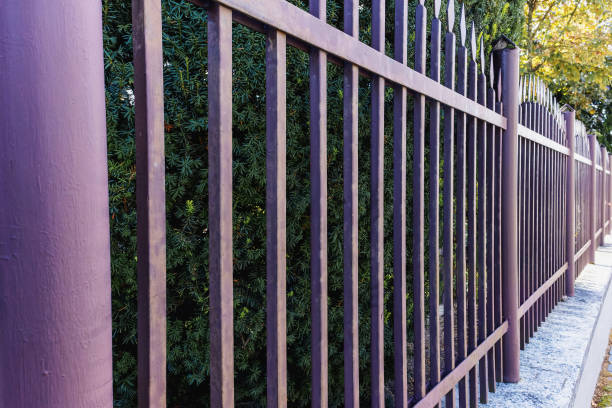 istock brown metal fence on a sunny day, side view 2148234615