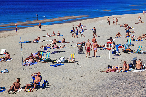 Tylesand, Sweden-July, 2020: Sand beach with sunbathing people a sunny summer day
