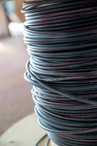 Large spool of black and gray electrical cable