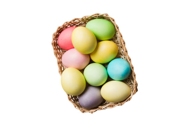 istock Basket of colorful Easter eggs isolated on white background. Easter basket filled with colored eggs top view holiday concept 2148236597