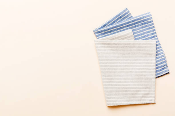 istock top view with gray kitchen napkin isolated on table background. Folded cloth for mockup with copy space, Flat lay. Minimal style 2148236665