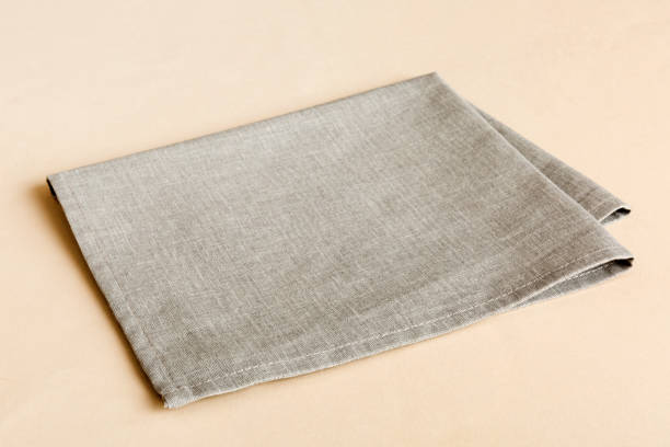 istock top view with gray kitchen napkin isolated on table background. Folded cloth for mockup with copy space, Flat lay. Minimal style 2148236669