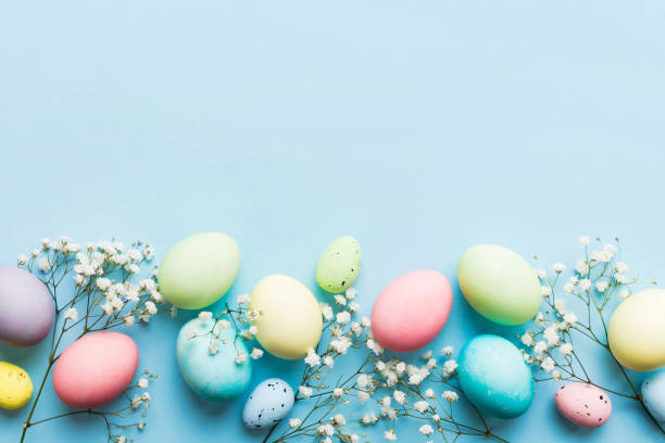 istock Happy Easter composition. Easter eggs on colored table with gypsophila. Natural dyed colorful eggs background top view with copy space 2148236671