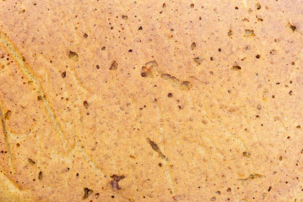istock Overhead view of a cake with a warm beige crumbly texture. Organic texture abstract background. 2148237730