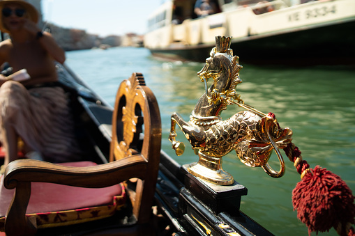 Gondola ride on a canal of Venice in Italy, view from the gondola.Gondola detail.