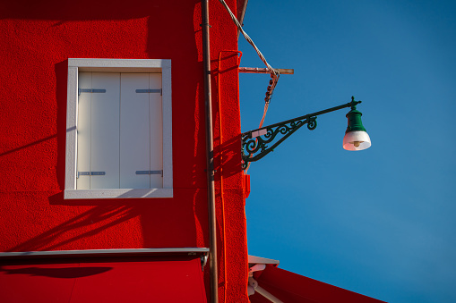 Red wooden house facade with window