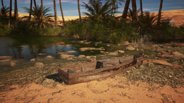 A boat sitting on top of a sandy beach