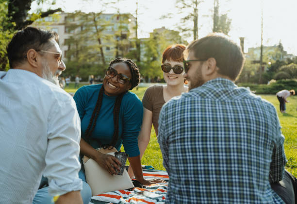 istock Group of diverse friends outdoors on picnic 2148239907