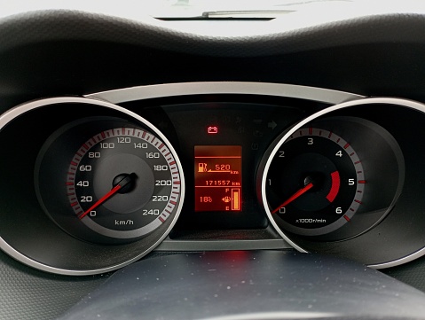 Dashboard on an old car with speedometer and tachometer and mileage measurement. A small screen on which the necessary information for the movement of the car is displayed.