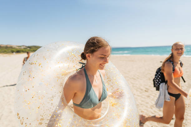 Photo of a couple of female friends having fun on a weekend getaway on local beach