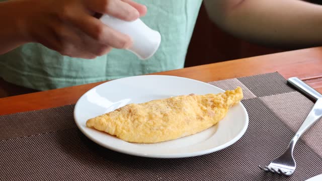 Seasoning an Omelette at the Table
