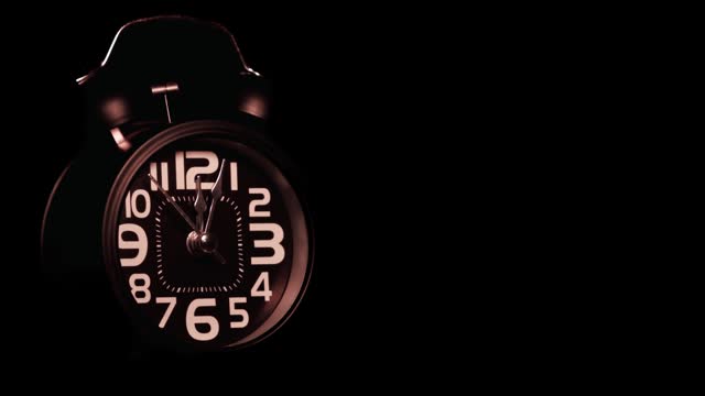 Black retro alarm clock on dark background
