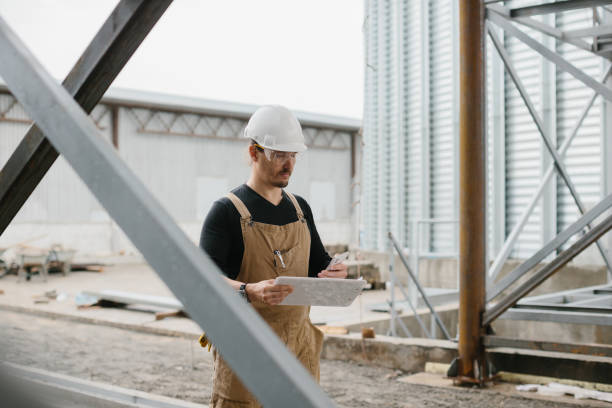istock An engineer inspects the construction of grain storage silos. 2148240913