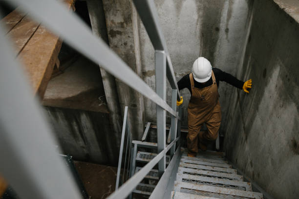 istock A construction engineer climbs a metal ladder at the construction site of a grain silo. 2148240943
