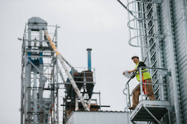istock A male industrial worker stands on a grain silo with documents in his hands and makes a visual inspection. 2148241030