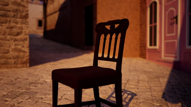 A wooden chair sitting on top of a cobblestone street