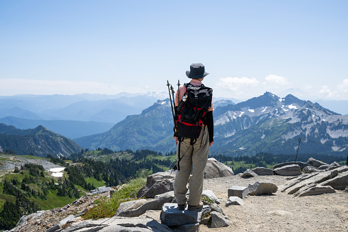Man looking at the mountain views at Skyline Trail. Mt Rainier National Park. Washington State.
