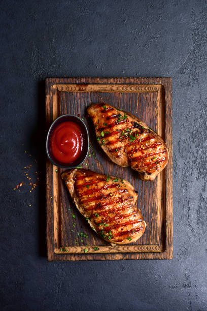 istock Grilled spicy chicken breasts. Top view with copy space. 2148242363