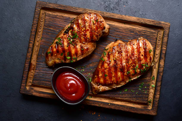 istock Grilled spicy chicken breasts. Top view with copy space. 2148242364