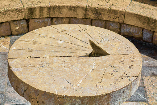This stone sundial, located in the historic city of Tarragona, displays numerical engravings and hour lines, reflecting the ancient measurement of time.