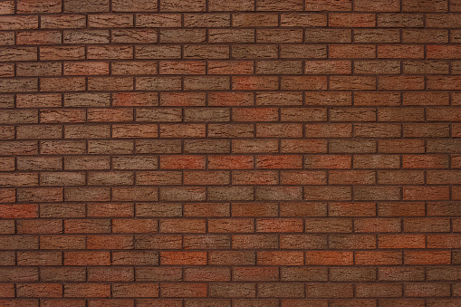 The texture of a decorative brick is brown. Close-up