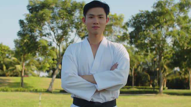 Portrait of Gen Z Asian Sportsman Wearing Dobok and Black Belt