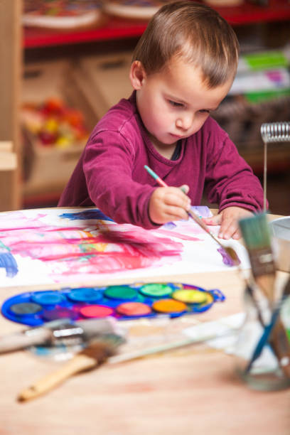 istock Little boy painting on a canvas with watercolors. 2148252021