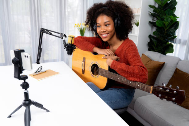 istock Host channel of African greeting on smartphone on broadcast studio. Tastemaker. 2148252042