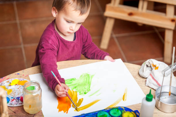 istock Little boy painting his white canvas with acrylic paints. 2148252174