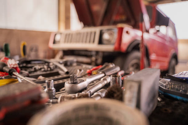 Off road vehicle in repair shop with hood open and elevated