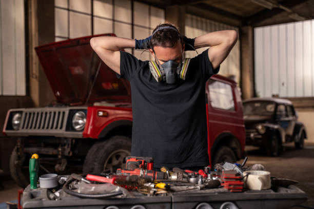 istock Repairman puts on protective air mask 2148253230