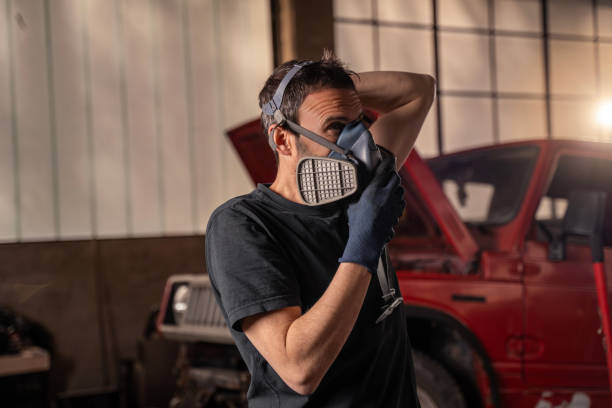 istock Repairman puts on protective air mask 2148253292