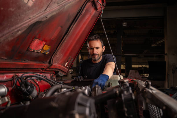 Mechanic repairs vehicle in shop